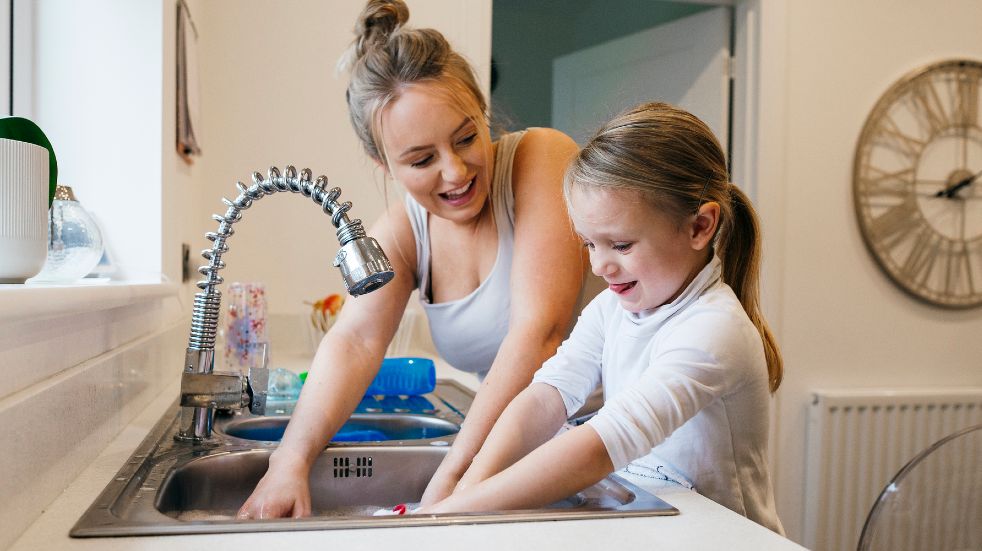 Mother daughter washing up